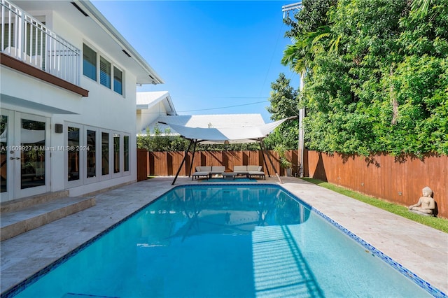 view of pool with a patio area and french doors