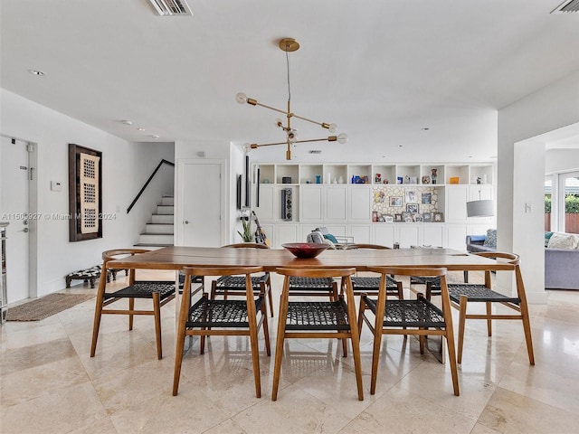 dining space with a chandelier and light tile patterned floors