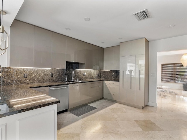 kitchen with dark stone counters, sink, tasteful backsplash, dishwasher, and gray cabinets