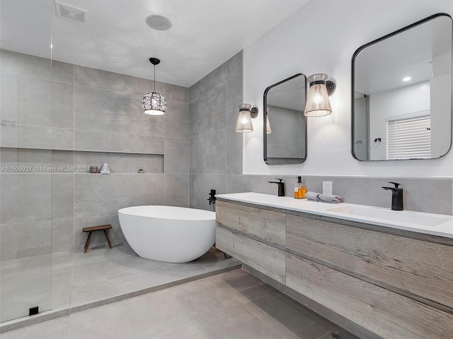 bathroom featuring tile walls, double sink vanity, and tile patterned floors