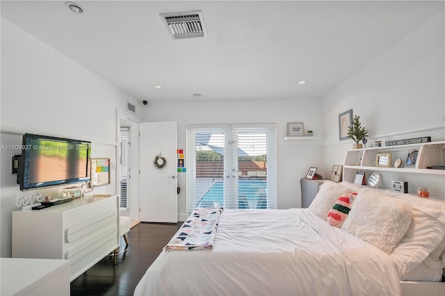 bedroom featuring dark hardwood / wood-style flooring, french doors, and access to exterior