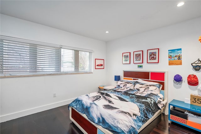 bedroom with dark hardwood / wood-style floors