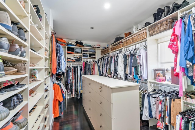 walk in closet with dark hardwood / wood-style flooring