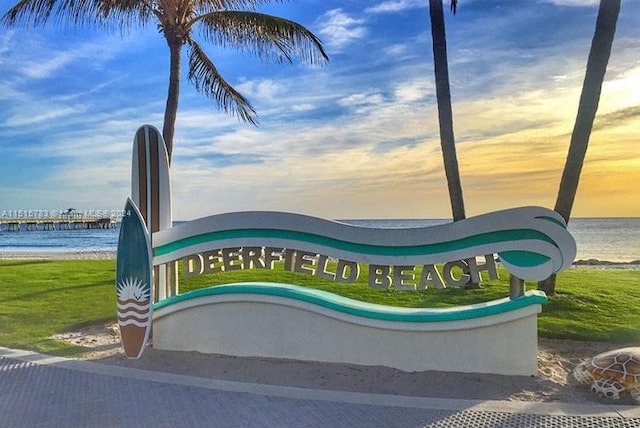 community sign featuring a water view