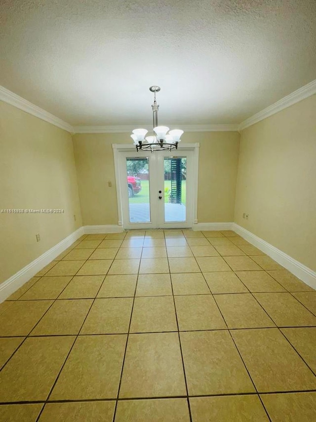 tiled empty room featuring a textured ceiling, a chandelier, crown molding, and french doors