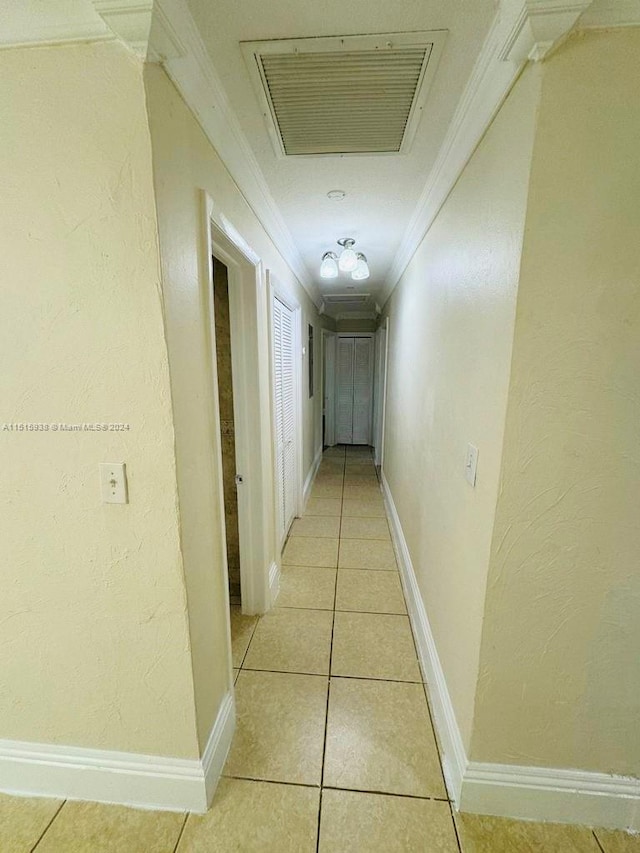 corridor featuring light tile floors