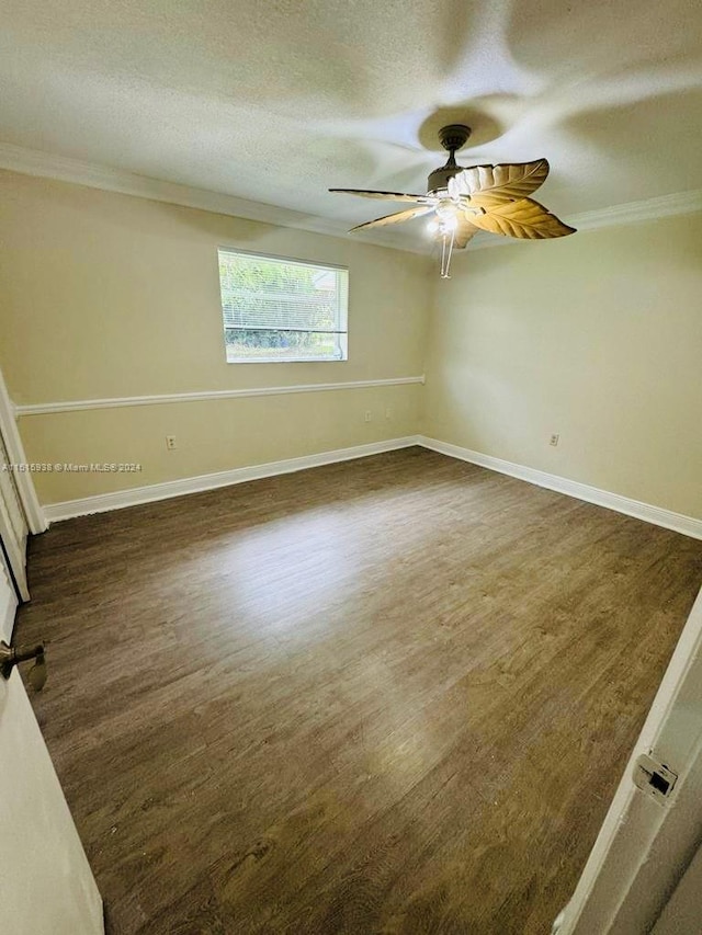 spare room featuring ornamental molding, ceiling fan, and dark hardwood / wood-style floors