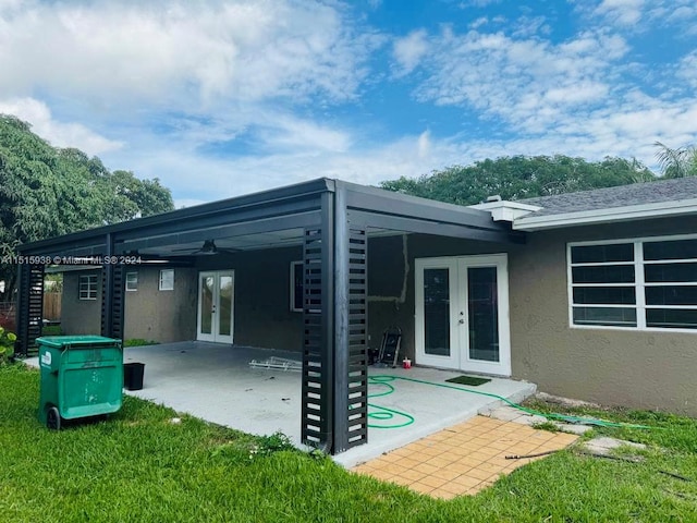 rear view of property featuring french doors, ceiling fan, and a patio area