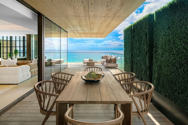 balcony with a water view and an outdoor hangout area