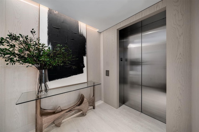 corridor featuring light hardwood / wood-style floors and elevator