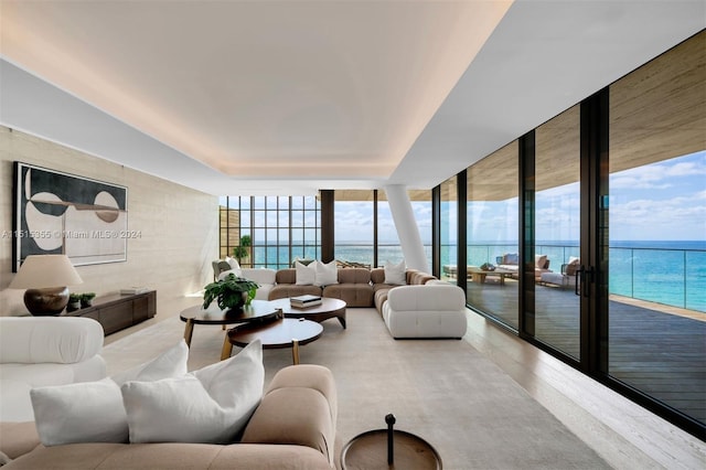 living room with a water view and a wall of windows