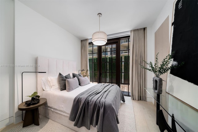 bedroom featuring light hardwood / wood-style floors and access to exterior