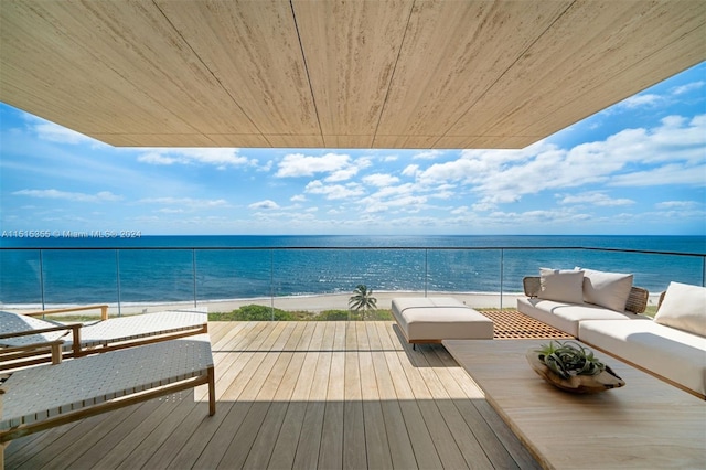 balcony with outdoor lounge area and a water view