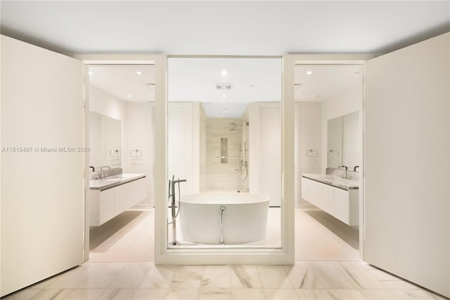 bathroom featuring vanity, tile floors, and independent shower and bath