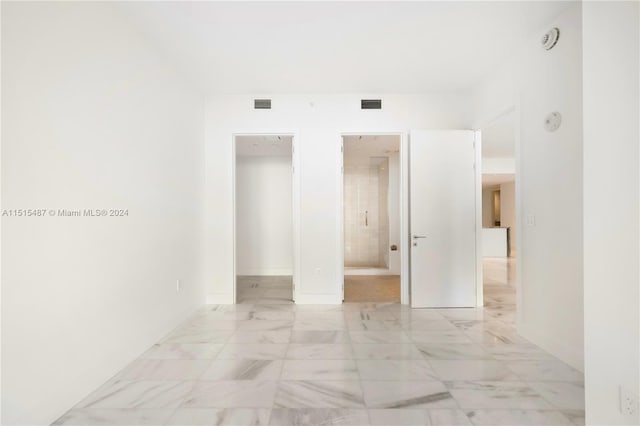 hall featuring light tile flooring