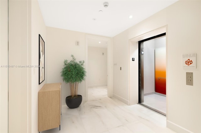 hallway featuring light tile floors