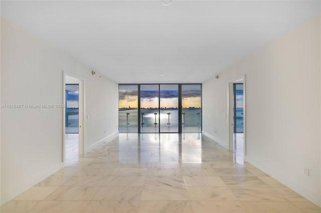 tiled empty room with floor to ceiling windows