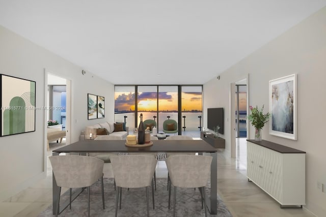 dining area featuring floor to ceiling windows and light tile flooring