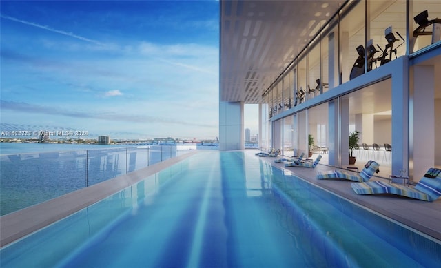 view of swimming pool featuring a water view