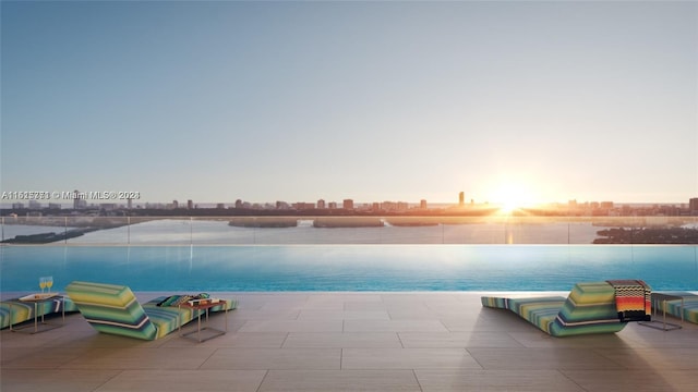 pool at dusk with a water view