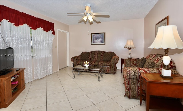 tiled living room with ceiling fan and a textured ceiling