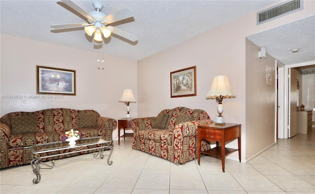 tiled living room with ceiling fan and a textured ceiling