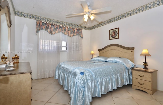 tiled bedroom featuring ceiling fan and a textured ceiling