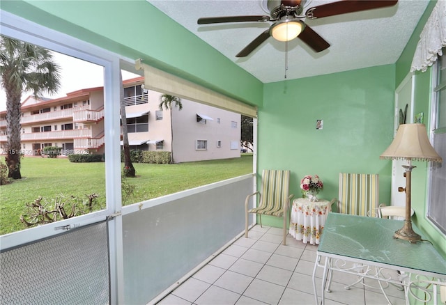 unfurnished sunroom featuring ceiling fan