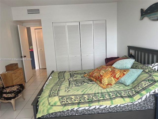 tiled bedroom featuring a closet