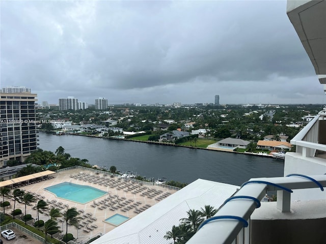 exterior space featuring a water view, a patio area, and a community pool