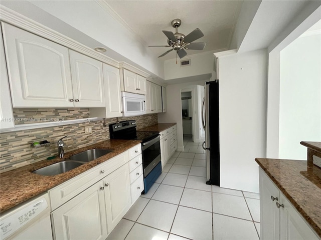 kitchen featuring ceiling fan, sink, white cabinets, stainless steel appliances, and tasteful backsplash