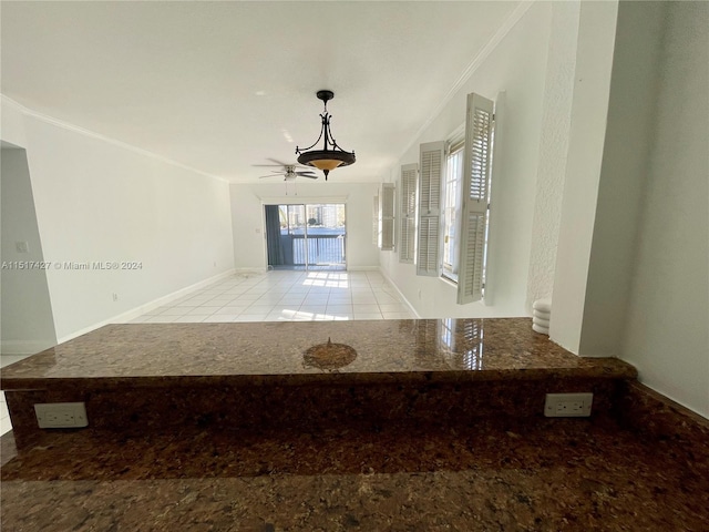 corridor with ornamental molding and light tile floors