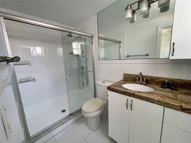 bathroom with tile walls, toilet, tile floors, tasteful backsplash, and large vanity