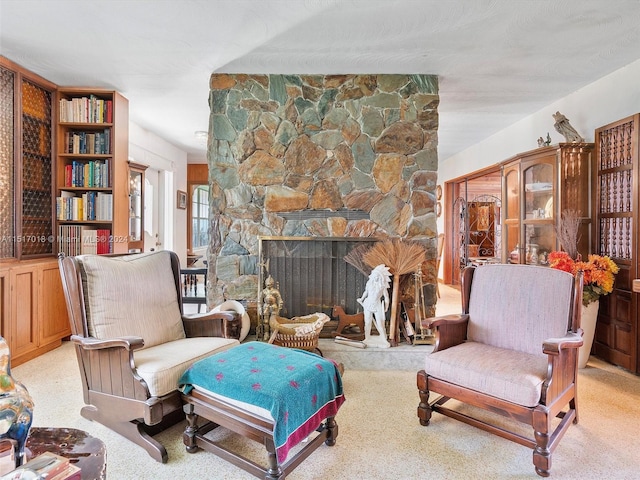 living room with a fireplace and light colored carpet