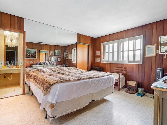 bedroom with wood walls and ensuite bath