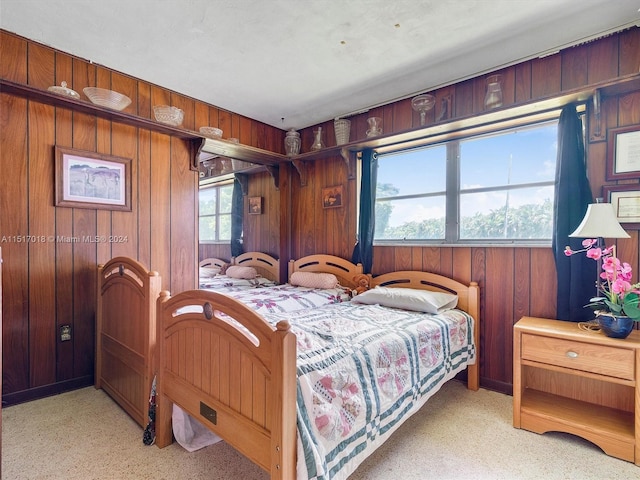 bedroom featuring wood walls