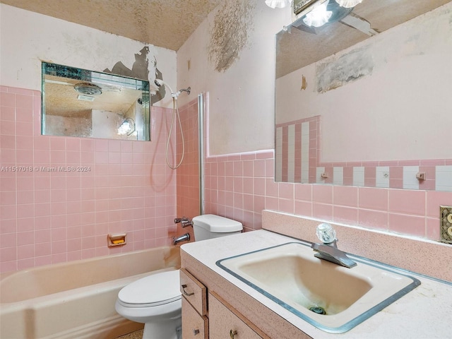 full bathroom featuring vanity, tiled shower / bath, tasteful backsplash, and tile walls