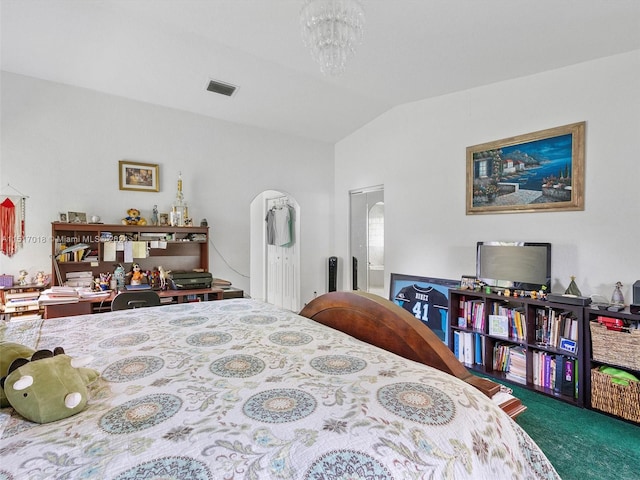 carpeted bedroom with vaulted ceiling and a chandelier