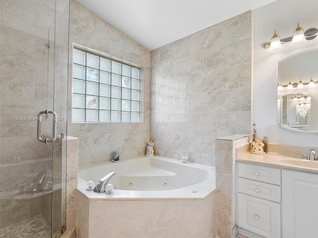 bathroom with plus walk in shower, vanity, lofted ceiling, and tile walls