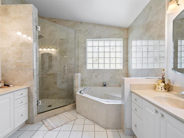 bathroom with tile patterned flooring, independent shower and bath, vaulted ceiling, and vanity