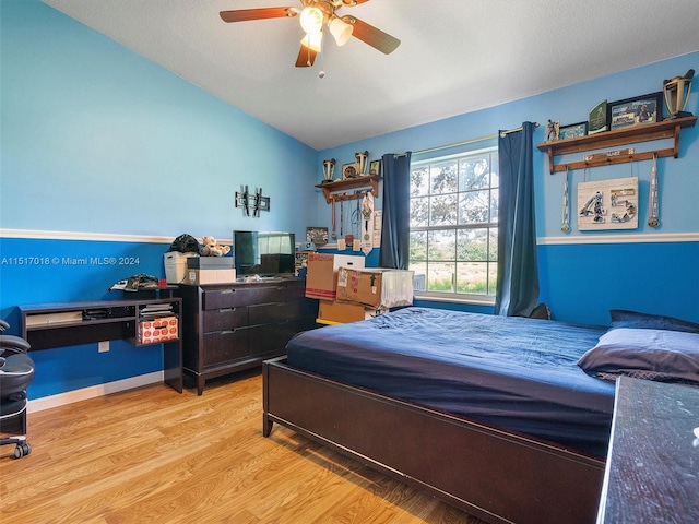 bedroom featuring ceiling fan, lofted ceiling, and light hardwood / wood-style floors