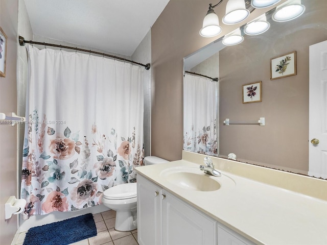 bathroom featuring vanity, tile patterned floors, and toilet