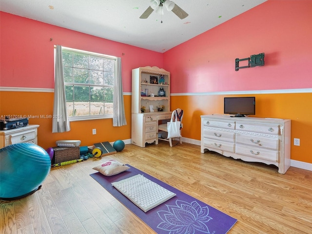 interior space with hardwood / wood-style flooring, vaulted ceiling, and ceiling fan