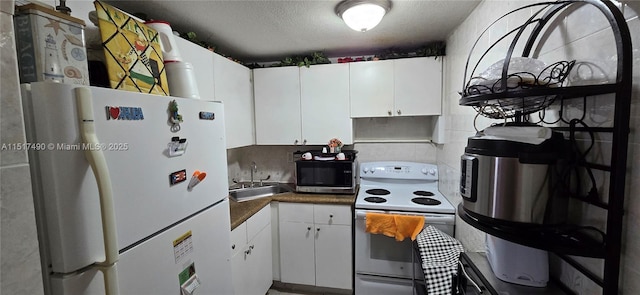 kitchen with sink, a textured ceiling, white appliances, decorative backsplash, and white cabinets