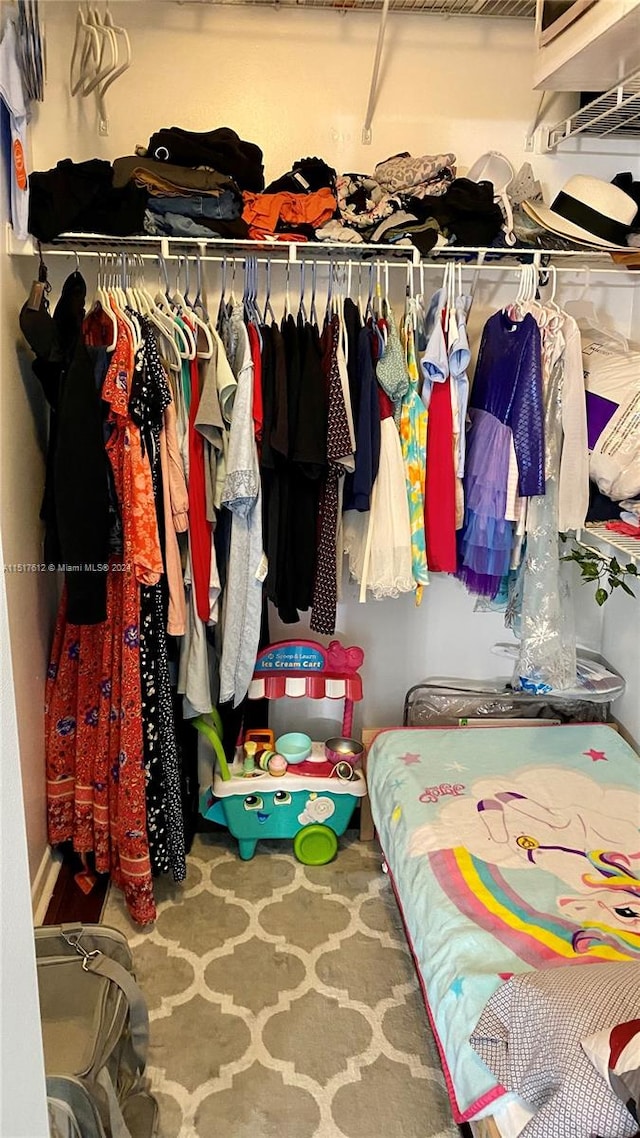 walk in closet with carpet floors