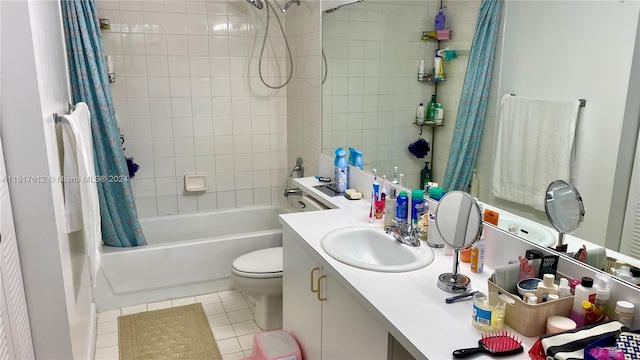 full bathroom featuring tile flooring, large vanity, toilet, and shower / bathtub combination with curtain