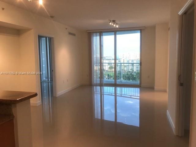 empty room with floor to ceiling windows and a wealth of natural light