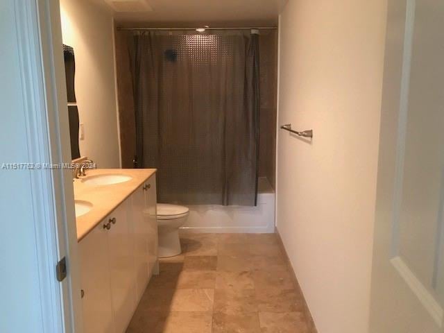 bathroom featuring tile floors, toilet, and vanity