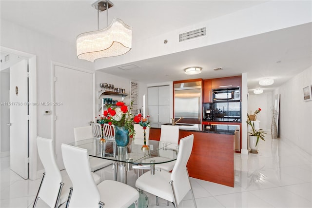 dining room featuring light tile flooring and sink