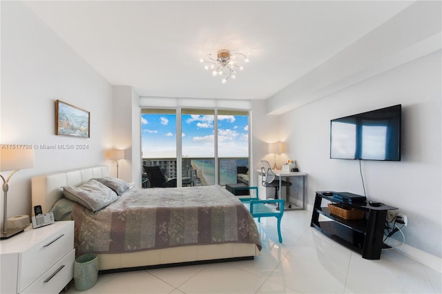 bedroom with a notable chandelier, floor to ceiling windows, access to exterior, and light tile flooring